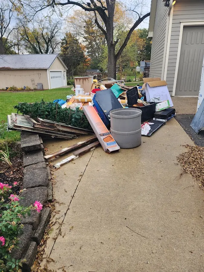 Dumpster being loaded with debris for Demolition Dumpster Rental in Rochester